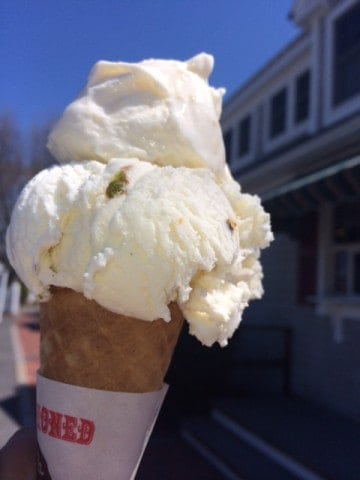 An ice cream cone with vanilla ice cream