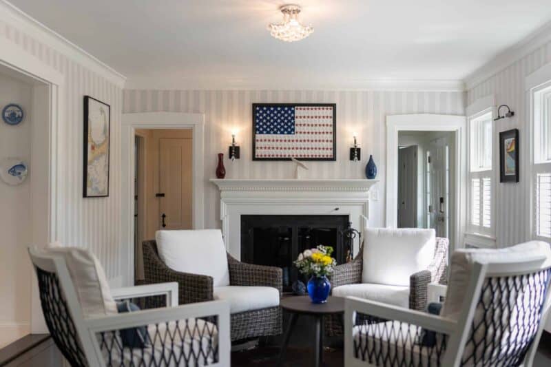 Inviting sitting room with comfortable white chairs in front of a fireplace