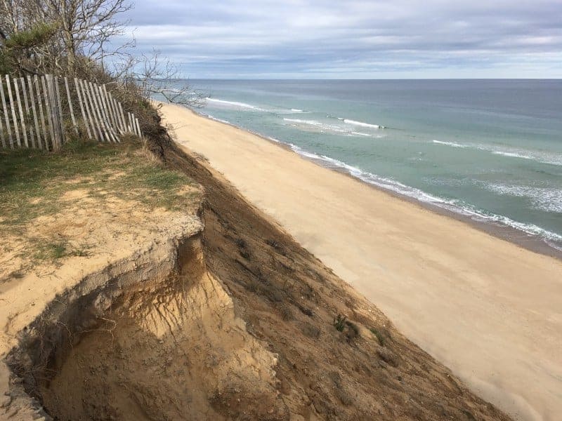 Steep sand dunes of cape cod leading down the to beach and ocean