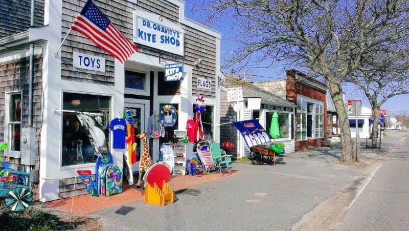 The main street in Harwich Port with many store fronts including Dr. Gravity's Kite Shop