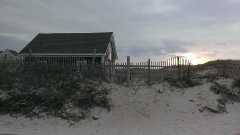 Dune shack near the beach at sunset