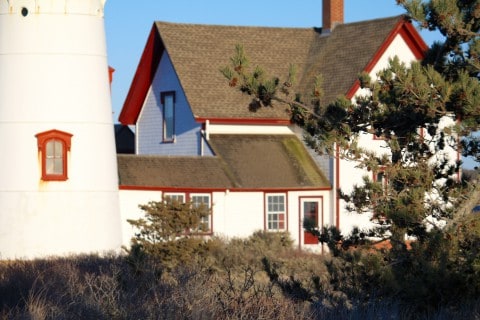 a close up of a red and white light house and building