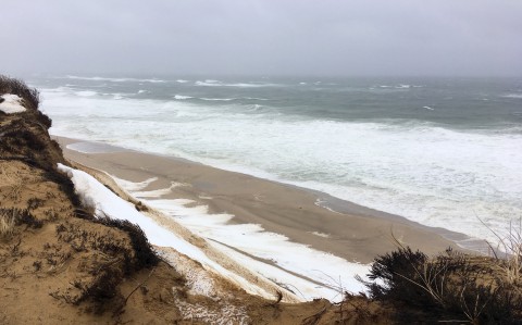 A rough sea with pounding waves onto the shore