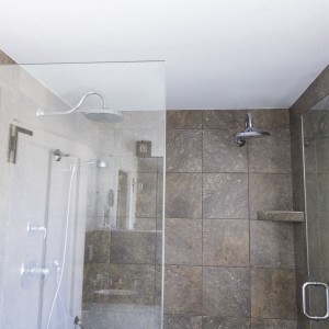 Brown tiled shower with 2 rain shower heads