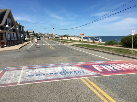 A street in Falmouth that is ready for the road race with a red, white and blue finish line painted on the street