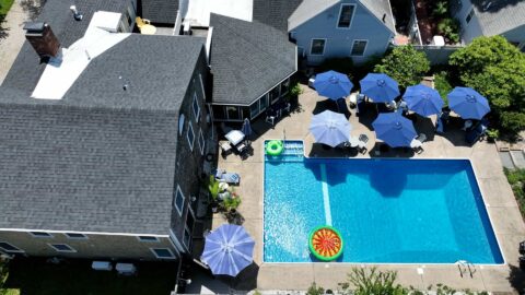Ariel view of The Platinum Pebble Boutique Inn, the pool area and gardens