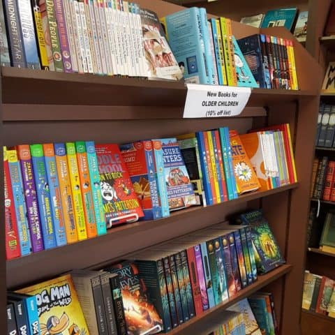 inside a bookstore showing shelves of brightly colored books