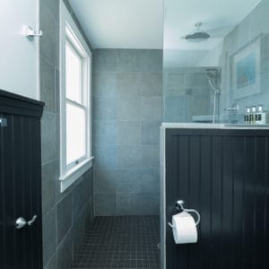 Bathroom with black walls and grey tiled shower