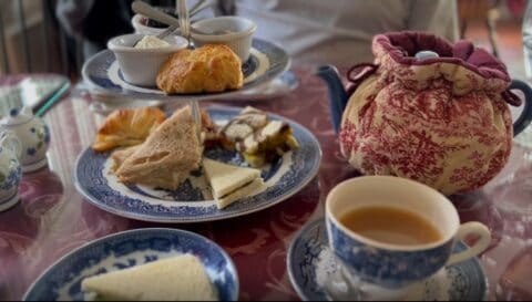 Table with tea, sandwiches & desserts