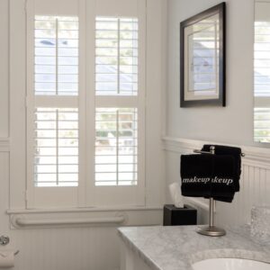 a bathroom in white showing the toilet and sink