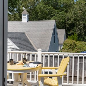 outdoor deck with white and yellow table and chairs