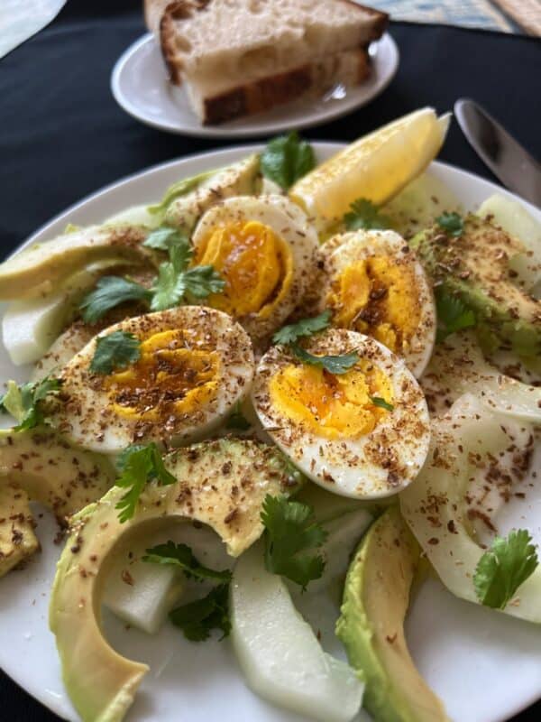 Mediterranean breakfast salad with farm fresh eggs avocado and lemon 